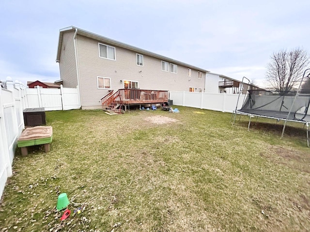 2193 Julie Ave, Sparta, WI 54656 - rear view of house featuring a lawn, a deck, a fenced backyard, and a trampoline