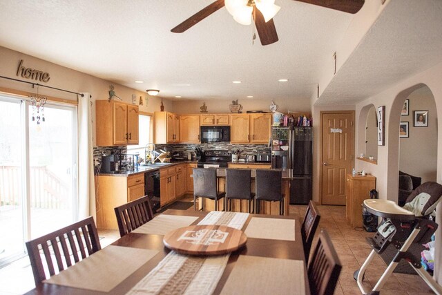 2193 Julie Ave, Sparta, WI 54656 - dining area with light tile patterned flooring, ceiling fan, recessed lighting, and arched walkways