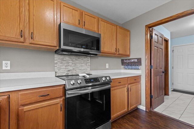 kitchen with light countertops, tasteful backsplash, and stainless steel appliances