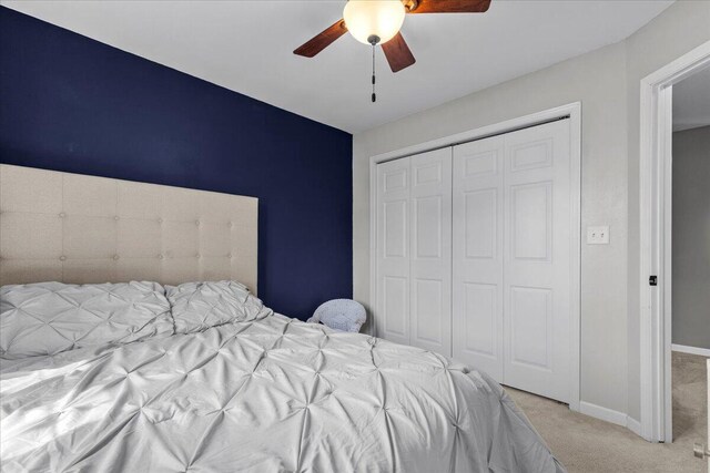 bedroom with carpet floors, baseboards, a closet, and ceiling fan