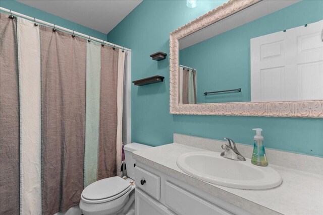 bathroom with toilet and vanity