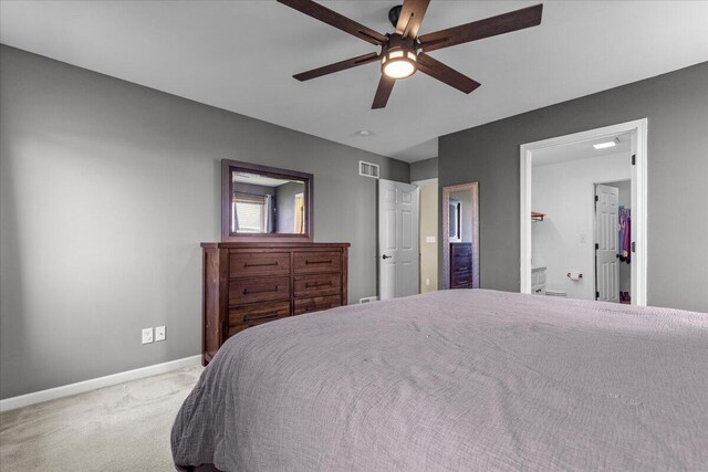 bedroom featuring visible vents, a ceiling fan, baseboards, and carpet floors