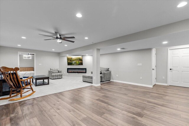 living area with baseboards, ceiling fan, recessed lighting, and wood finished floors