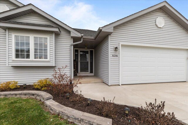 single story home featuring an attached garage and driveway