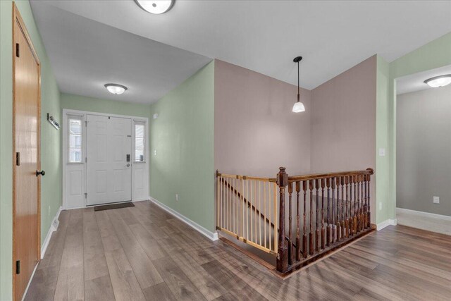 entrance foyer with baseboards and wood finished floors