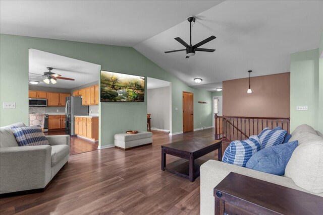 living room with a ceiling fan, baseboards, dark wood finished floors, and lofted ceiling