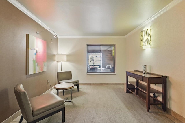 sitting room featuring baseboards, ornamental molding, and carpet