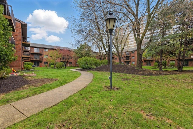 view of property's community with a lawn