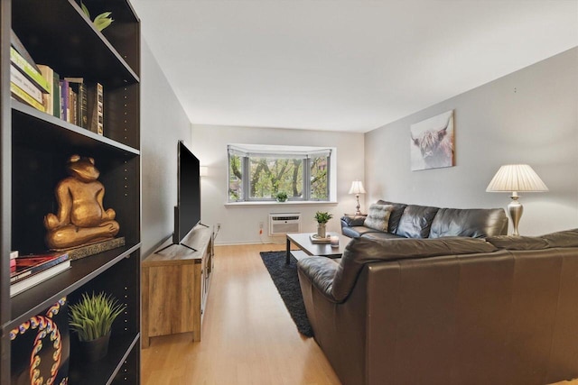 living room featuring an AC wall unit and wood finished floors