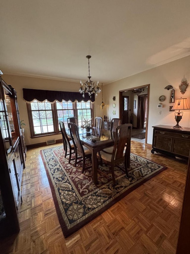3216 Moorland Ave, Racine, WI 53405 - dining space featuring crown molding, a notable chandelier, and visible vents