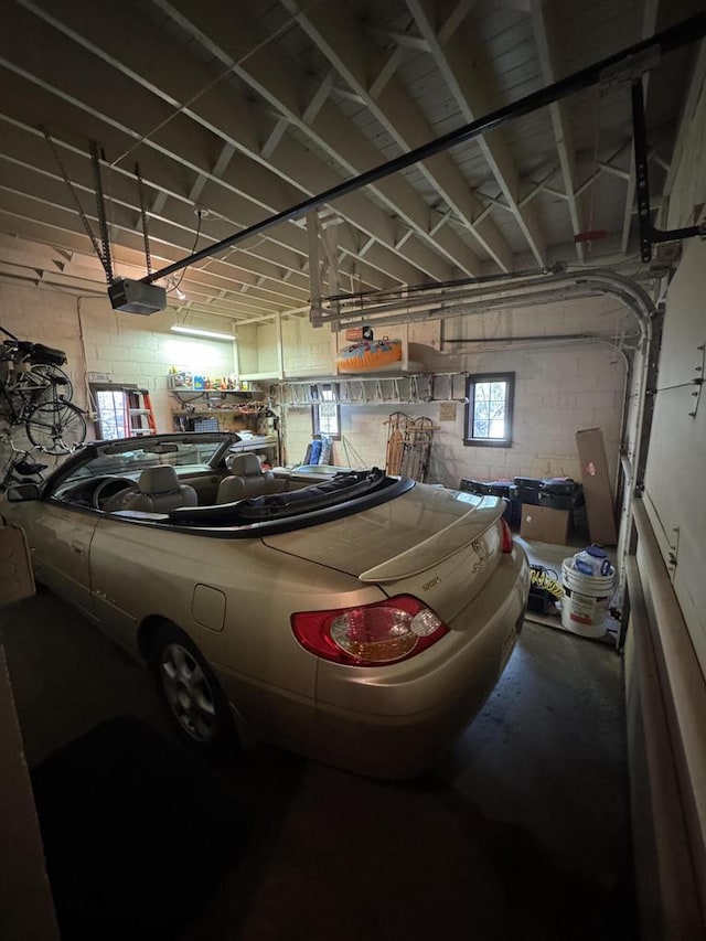 3216 Moorland Ave, Racine, WI 53405 - garage featuring a garage door opener and concrete block wall