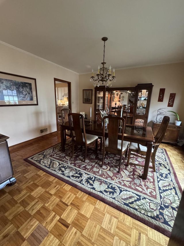 3216 Moorland Ave, Racine, WI 53405 - dining space featuring baseboards, ornamental molding, visible vents, and a chandelier