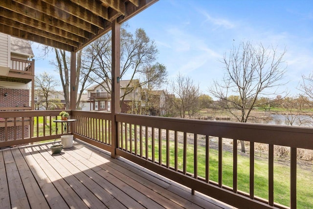 deck featuring a water view and a yard
