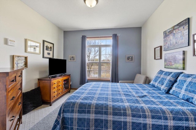 bedroom featuring light carpet