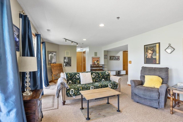 living area featuring carpet floors, recessed lighting, and visible vents