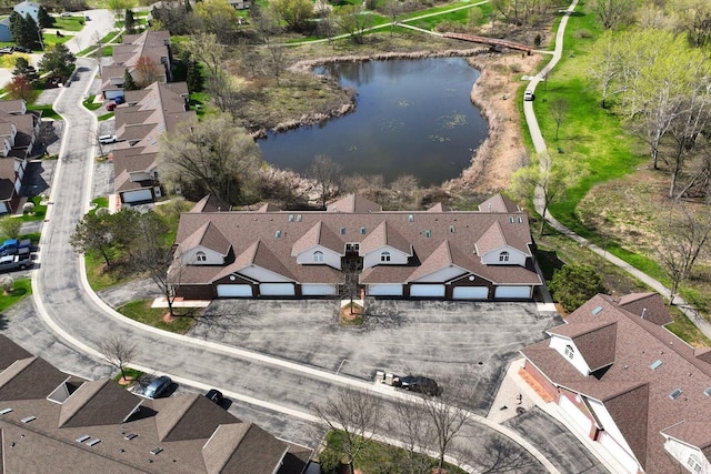 drone / aerial view featuring a water view and a residential view