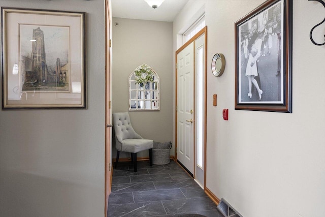 interior space featuring baseboards and visible vents