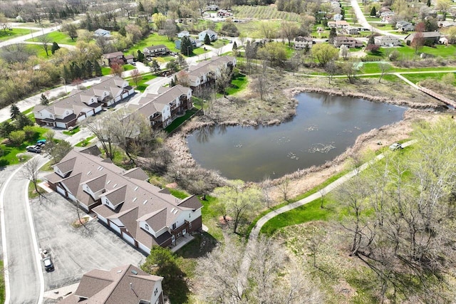 drone / aerial view with a water view and a residential view