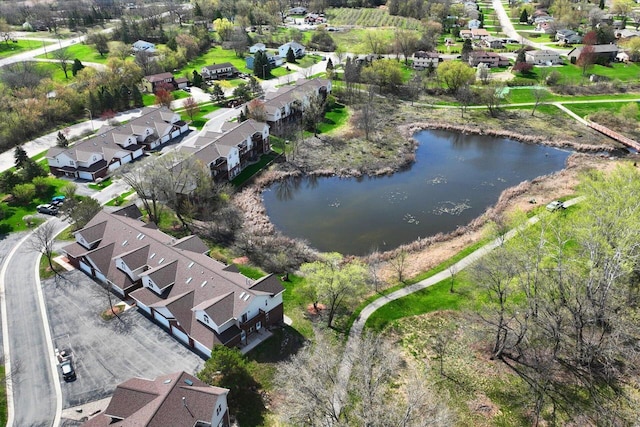 drone / aerial view with a water view and a residential view