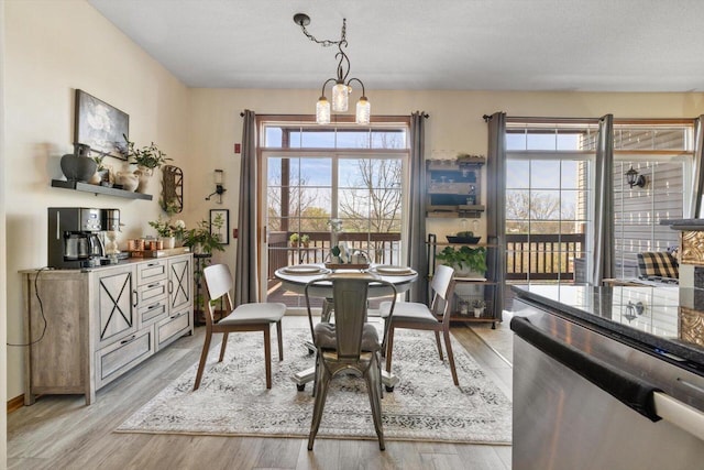 dining room with baseboards and light wood-type flooring