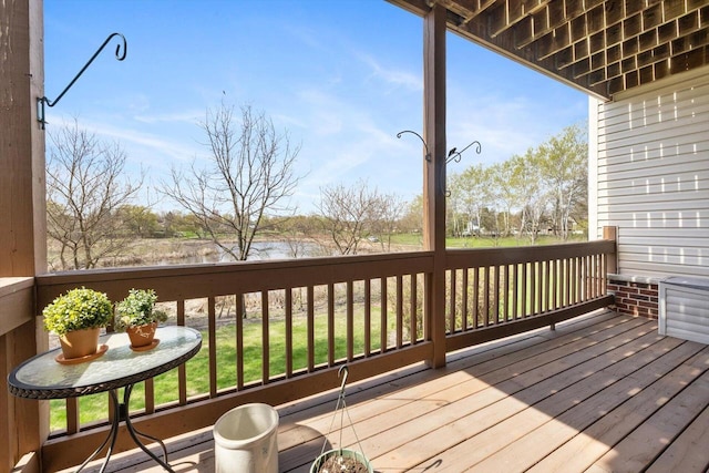 wooden deck featuring a water view