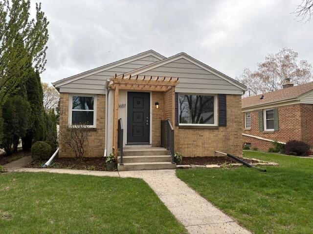 bungalow-style home featuring brick siding, a pergola, and a front yard