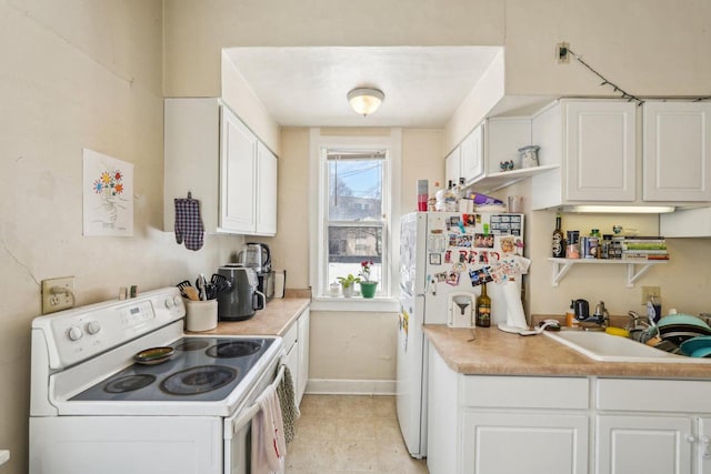 kitchen with baseboards, a sink, white cabinetry, and white appliances