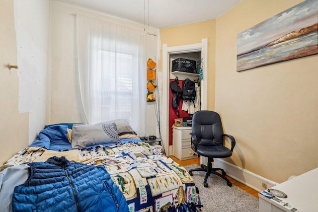 bedroom with baseboards and light wood-style flooring