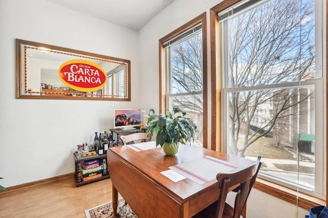 dining room with baseboards and light wood-style floors