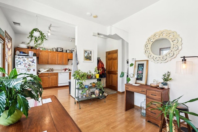 dining space with light wood-style flooring and visible vents