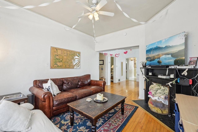 living area featuring ceiling fan, a high ceiling, and hardwood / wood-style flooring