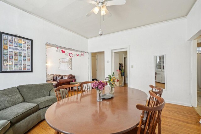 dining area with crown molding, ceiling fan, and light wood-style flooring