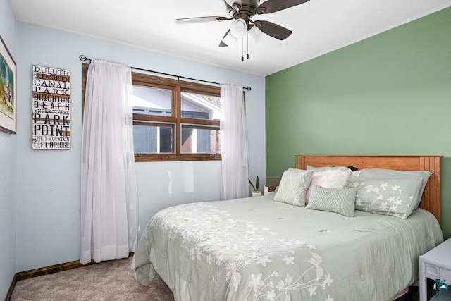 carpeted bedroom with baseboards and ceiling fan