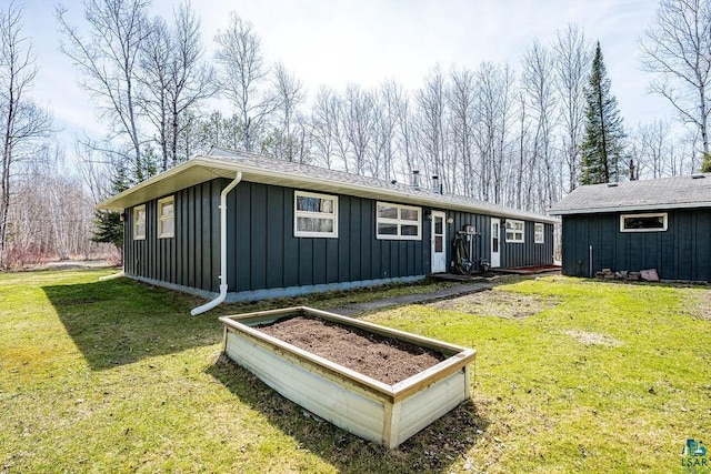 view of front of home featuring board and batten siding and a front lawn