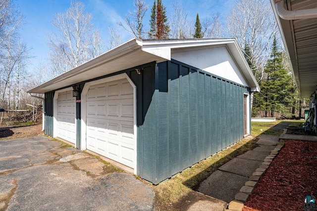 view of side of property featuring a detached garage
