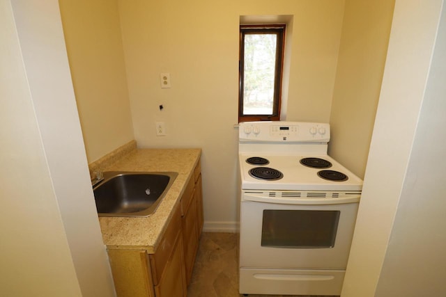 kitchen with a sink, light countertops, white electric range, and brown cabinets