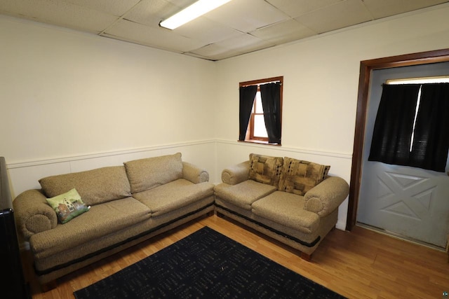 living room featuring a paneled ceiling and wood finished floors