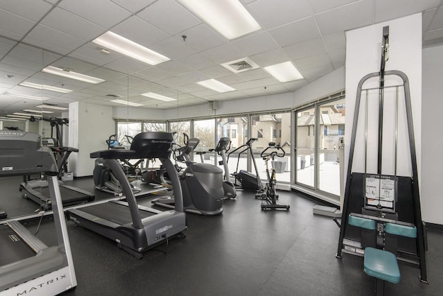 gym with visible vents and a paneled ceiling