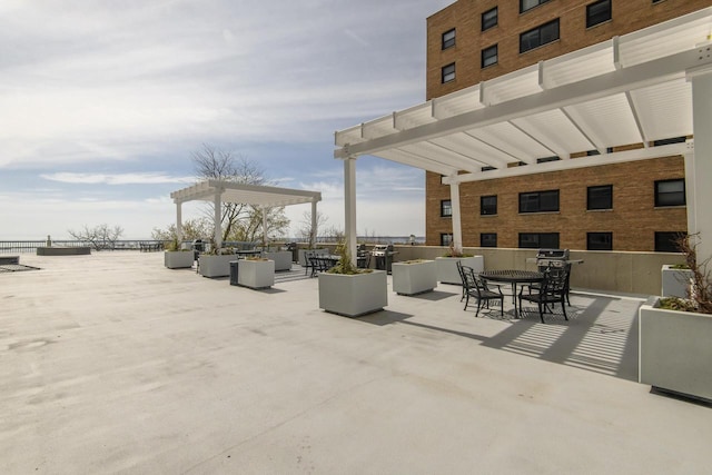 view of patio featuring outdoor dining space, a pergola, and outdoor lounge area