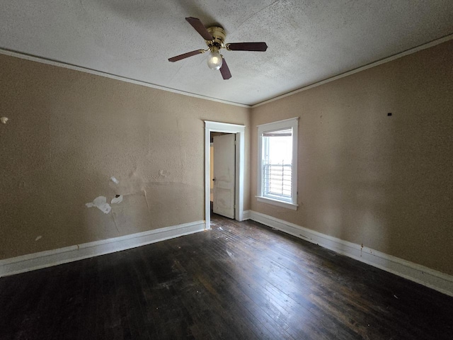 unfurnished room featuring a ceiling fan, a textured ceiling, wood finished floors, baseboards, and ornamental molding