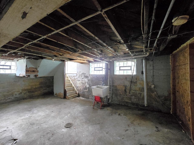 below grade area featuring a sink and stairway