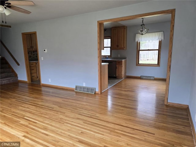 439 270th Ave, Cumberland, WI 54829 - unfurnished living room featuring visible vents, stairs, baseboards, a ceiling fan, and light wood-style flooring