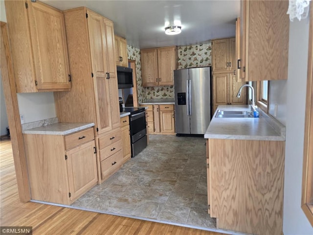 439 270th Ave, Cumberland, WI 54829 - kitchen featuring black microwave, a sink, stainless steel fridge with ice dispenser, light countertops, and range with electric stovetop