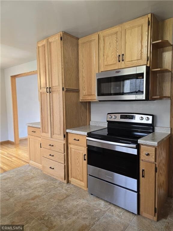 439 270th Ave, Cumberland, WI 54829 - kitchen featuring light countertops, open shelves, light brown cabinets, and stainless steel appliances