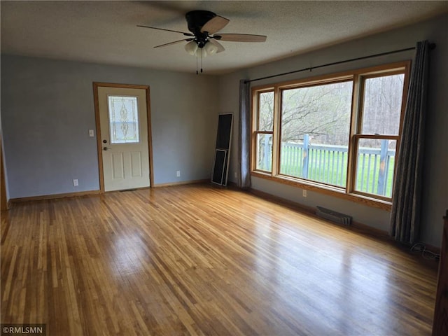 439 270th Ave, Cumberland, WI 54829 - spare room with wood finished floors, plenty of natural light, ceiling fan, and visible vents