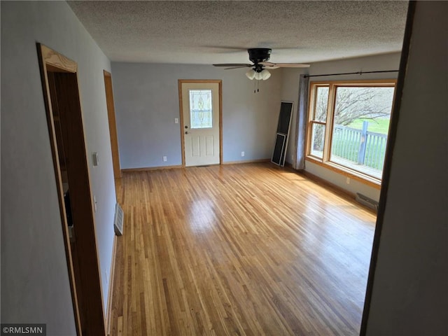 439 270th Ave, Cumberland, WI 54829 - empty room with baseboards, a textured ceiling, ceiling fan, and wood finished floors