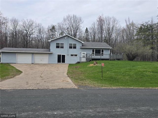 439 270th Ave, Cumberland, WI 54829 - tri-level home featuring a front lawn, an attached garage, concrete driveway, and a deck