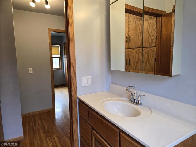 439 270th Ave, Cumberland, WI 54829 - bathroom with baseboards, vanity, and wood finished floors