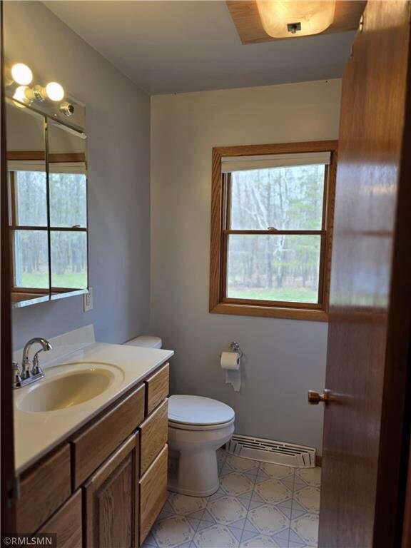 439 270th Ave, Cumberland, WI 54829 - bathroom featuring vanity, plenty of natural light, tile patterned floors, and toilet