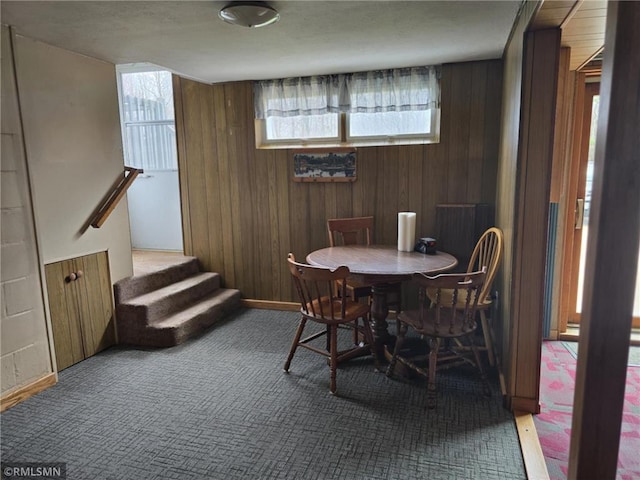 439 270th Ave, Cumberland, WI 54829 - dining space with carpet flooring, wooden walls, and stairway